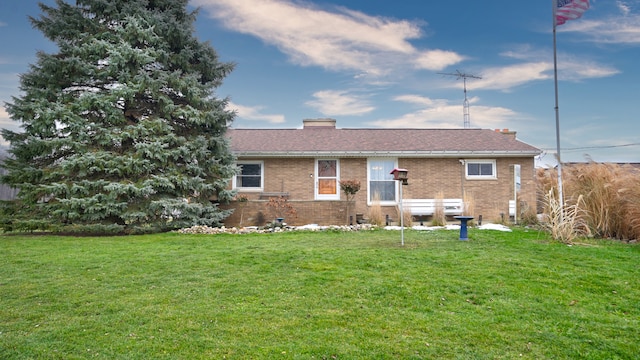 rear view of property with a yard