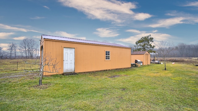 view of outbuilding featuring a yard