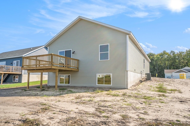 back of property with central AC and a deck