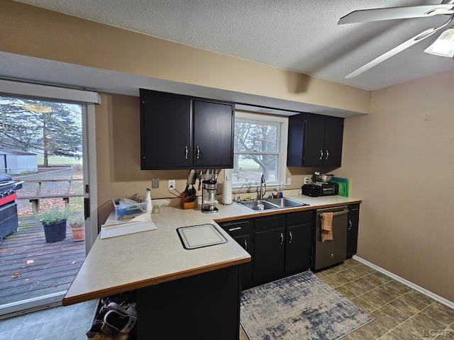 kitchen with dishwasher, a textured ceiling, a wealth of natural light, and sink