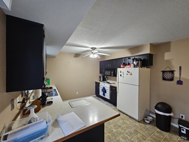 kitchen with a textured ceiling, ceiling fan, and white appliances