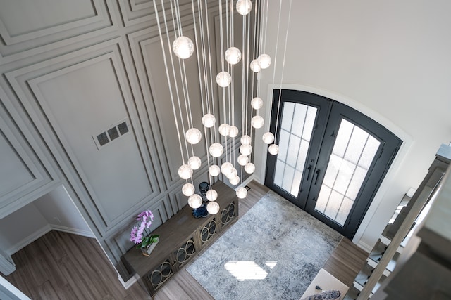 entryway with french doors and hardwood / wood-style flooring