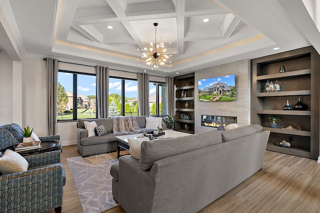 living room with coffered ceiling, built in shelves, beam ceiling, light hardwood / wood-style flooring, and a notable chandelier