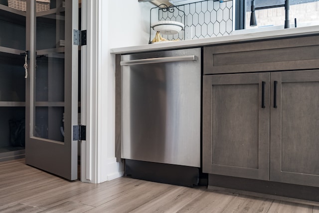 room details with light hardwood / wood-style flooring, stainless steel dishwasher, and sink