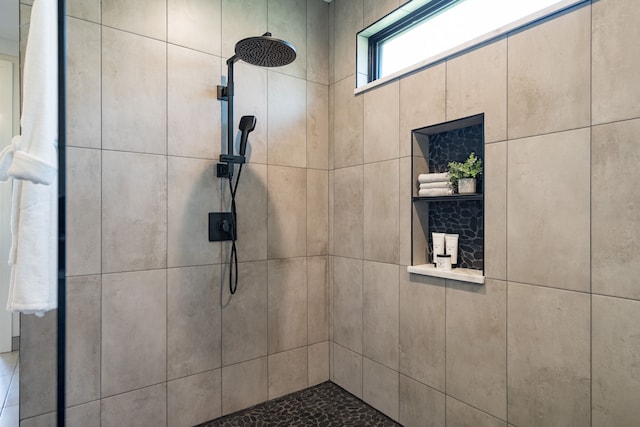 bathroom with tiled shower