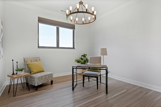 home office featuring light hardwood / wood-style flooring, ornamental molding, and a notable chandelier