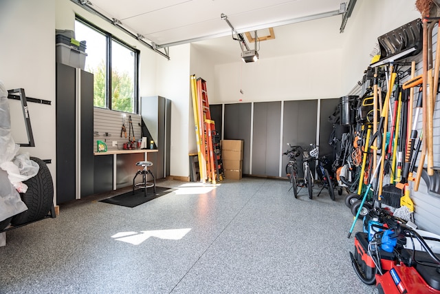 garage featuring a workshop area and a garage door opener