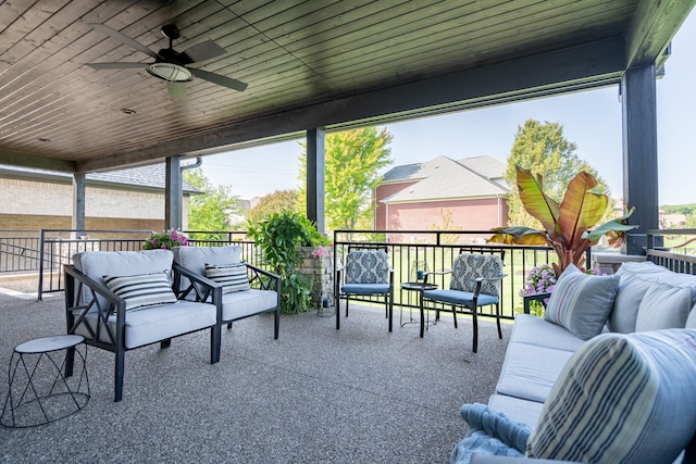 sunroom with a healthy amount of sunlight, ceiling fan, and wooden ceiling