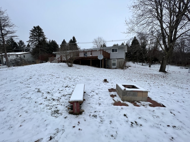 yard covered in snow with a wooden deck