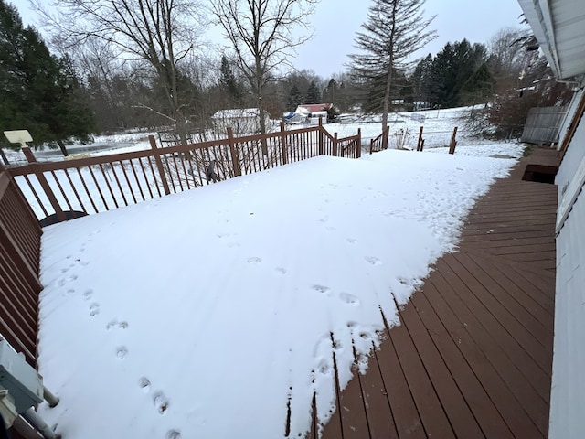 snowy yard with a deck