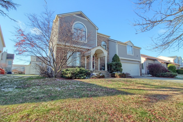 view of front of house with a front yard and a garage