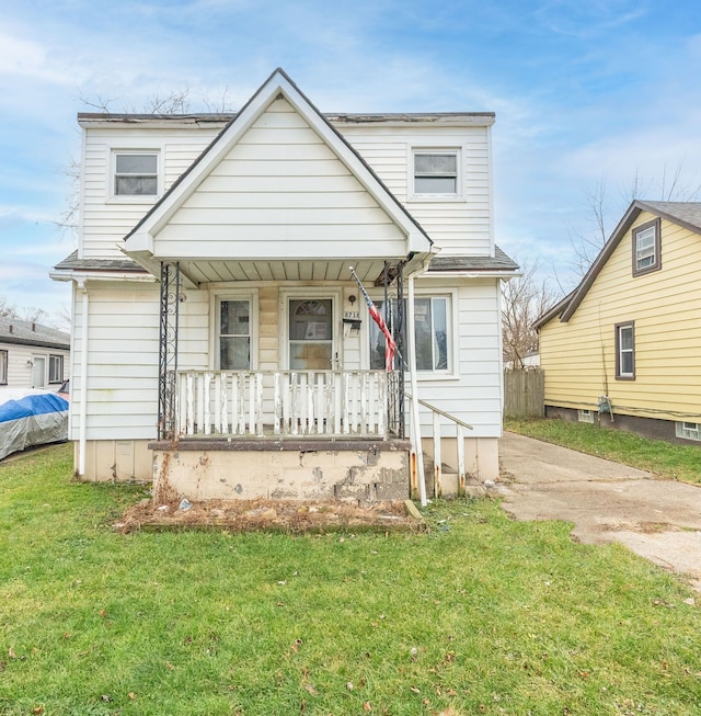 view of front of home with a porch and a front lawn