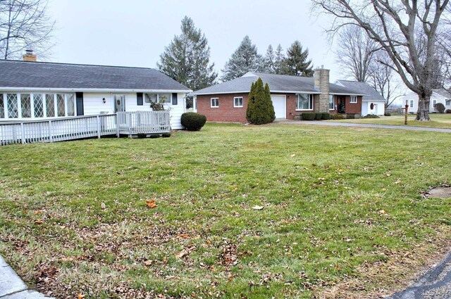 ranch-style house with a front lawn and a deck