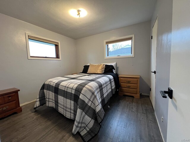 bedroom with dark hardwood / wood-style floors