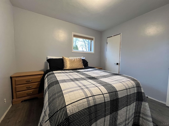 bedroom with baseboards and wood finished floors