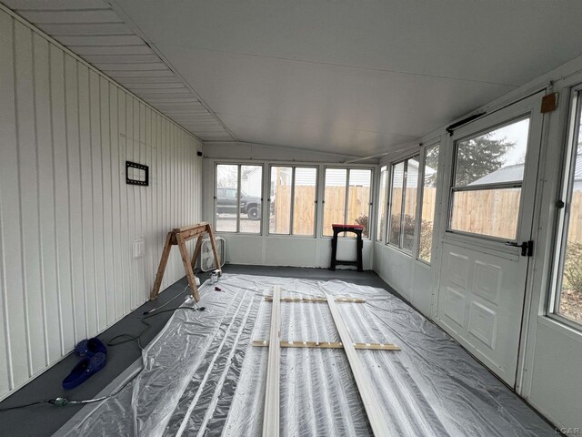 unfurnished sunroom with lofted ceiling