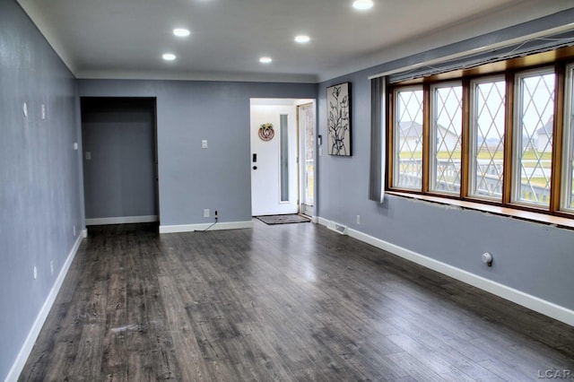 unfurnished room with dark hardwood / wood-style floors