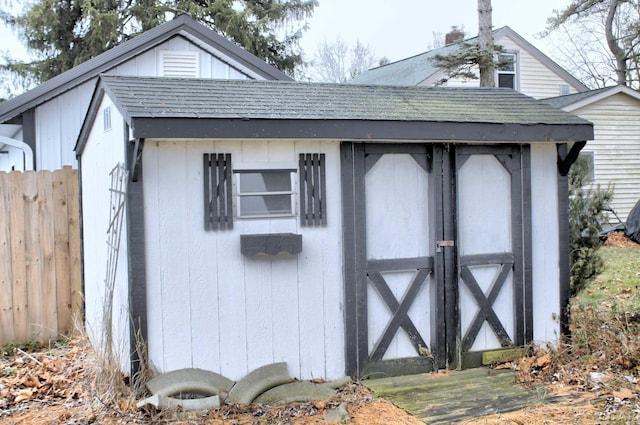 view of shed featuring fence