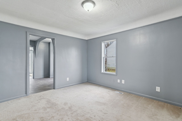 empty room featuring carpet flooring and a textured ceiling