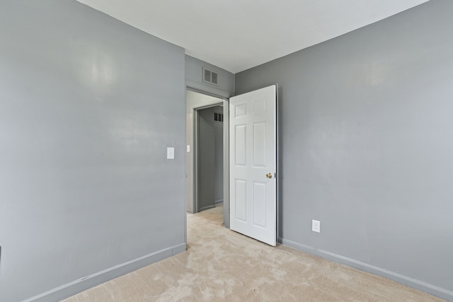 spare room with light colored carpet