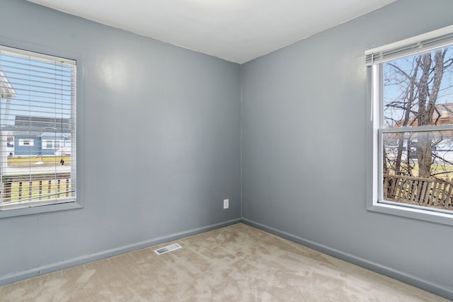 unfurnished room with light colored carpet