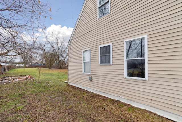 view of home's exterior with a yard