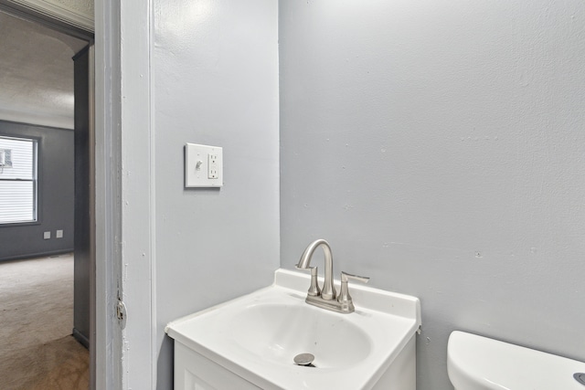 bathroom featuring vanity and toilet