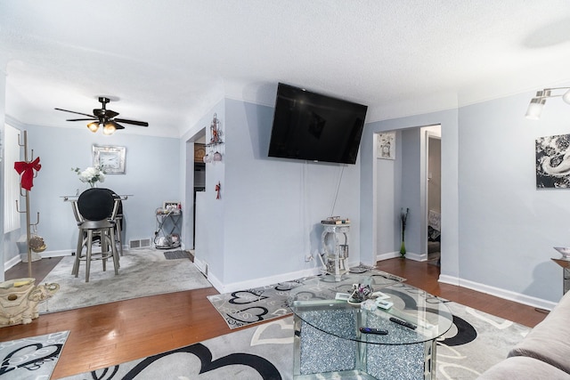 living room with hardwood / wood-style flooring and ceiling fan