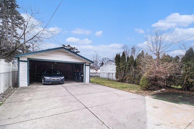 detached garage featuring fence