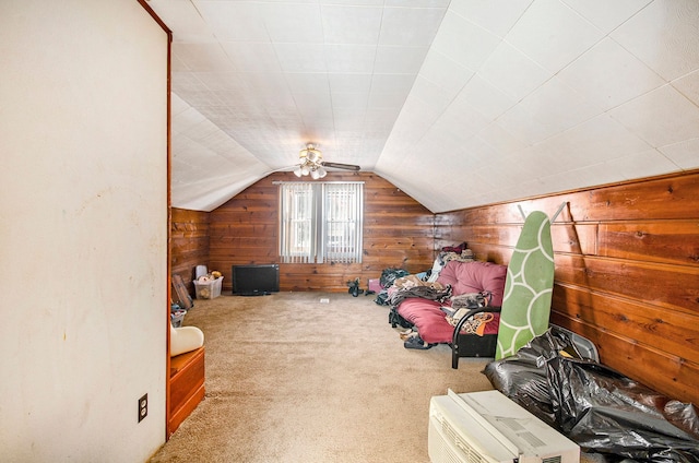 additional living space with lofted ceiling, wood walls, and carpet flooring