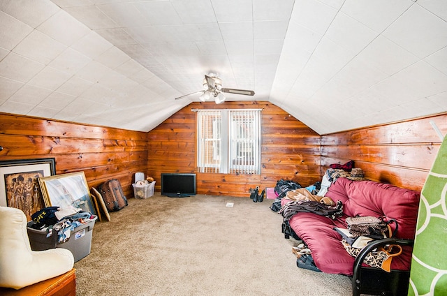 bonus room featuring lofted ceiling, carpet, and wood walls