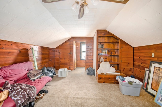 interior space with wood walls, carpet, and lofted ceiling