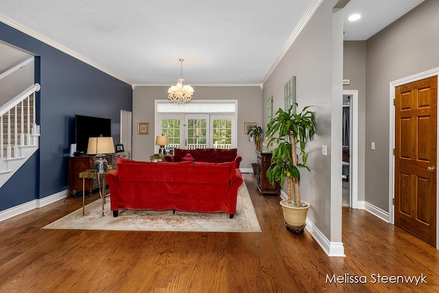 living room featuring a chandelier, dark hardwood / wood-style flooring, and crown molding