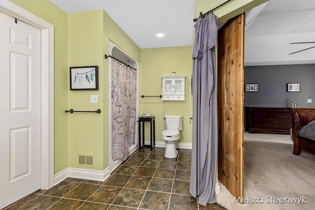 bathroom featuring ceiling fan and toilet