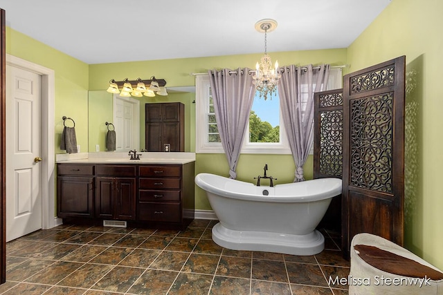 bathroom featuring a washtub, vanity, and a notable chandelier