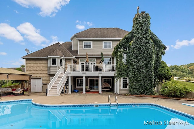 back of house with a swimming pool side deck, a patio area, and an outdoor living space