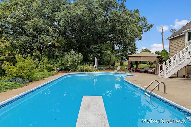 view of swimming pool with a gazebo, a diving board, and a patio