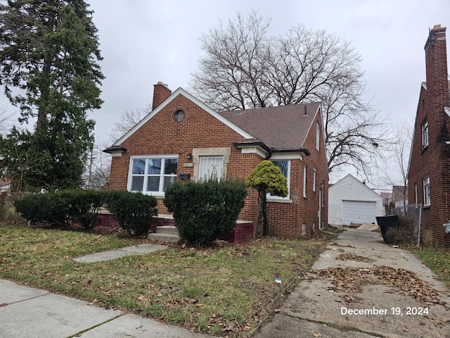 bungalow with a garage and an outbuilding