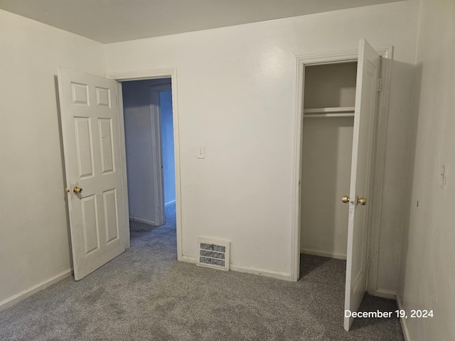 unfurnished bedroom featuring a closet and carpet floors