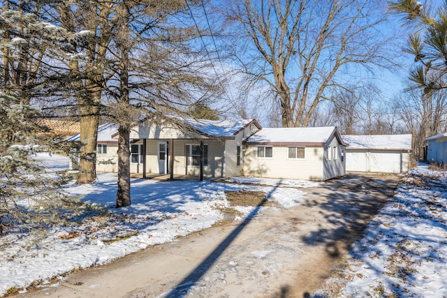 ranch-style home featuring a garage and an outbuilding