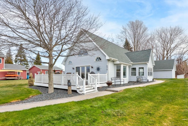 rear view of house with a yard and a deck