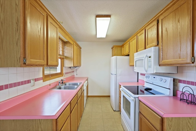 kitchen featuring a textured ceiling, white appliances, sink, and tasteful backsplash