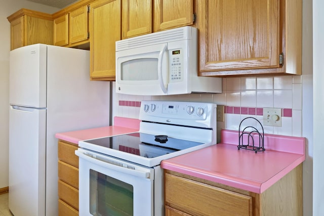 kitchen with white appliances and backsplash