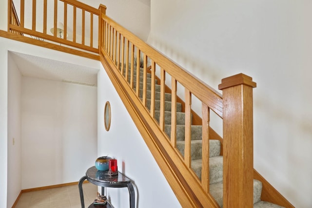 stairs featuring tile patterned floors