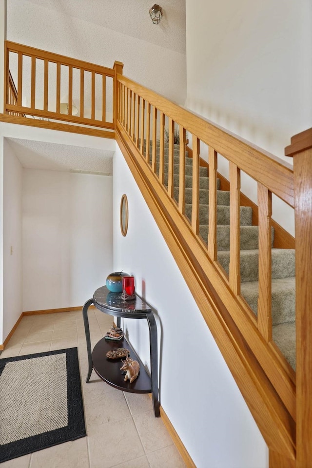 stairway with tile patterned flooring