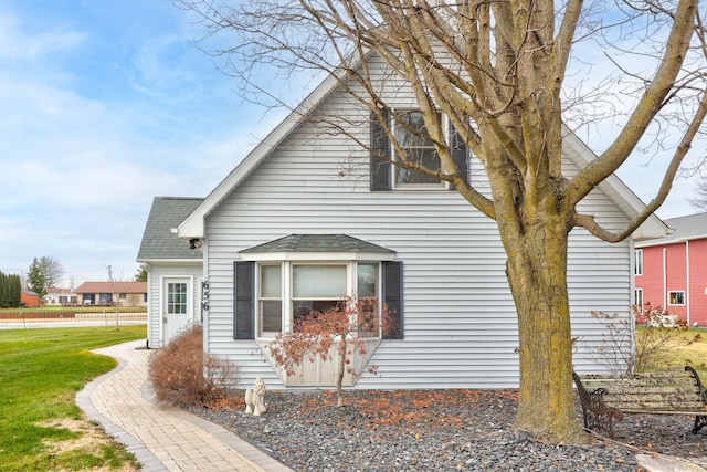 view of side of home featuring a yard