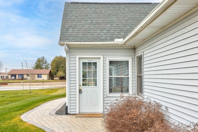 property entrance with a lawn