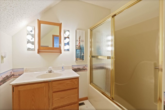 bathroom featuring tile patterned floors, vanity, enclosed tub / shower combo, and a textured ceiling