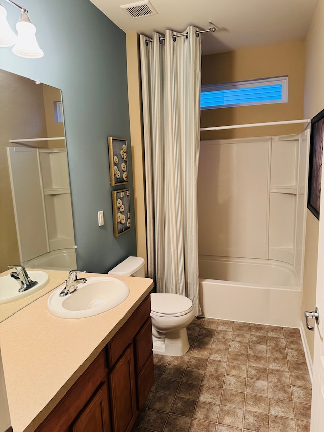 full bathroom with vanity, shower / bath combo, and toilet