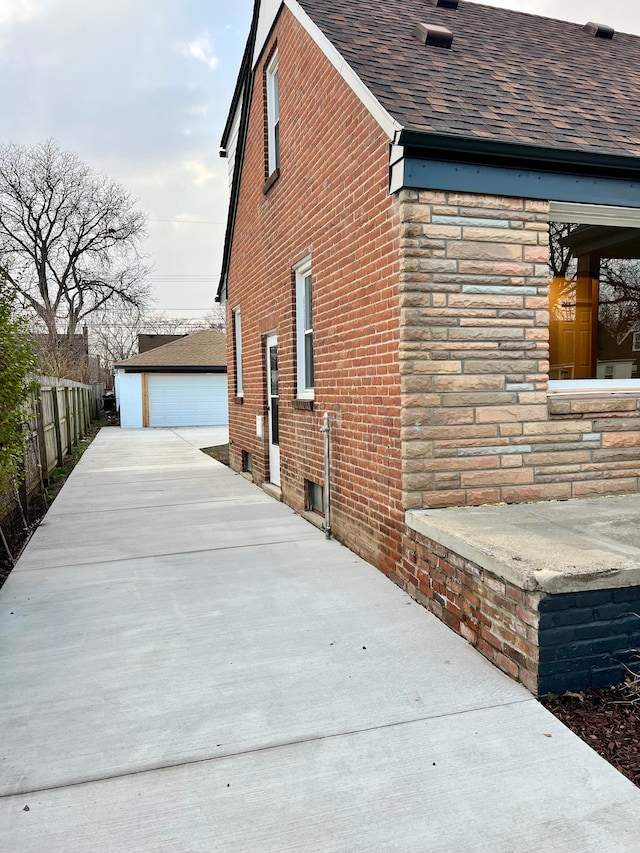 view of property exterior featuring an outdoor structure and a garage